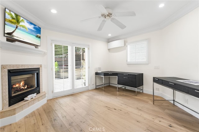 unfurnished office featuring ceiling fan, crown molding, and light hardwood / wood-style flooring