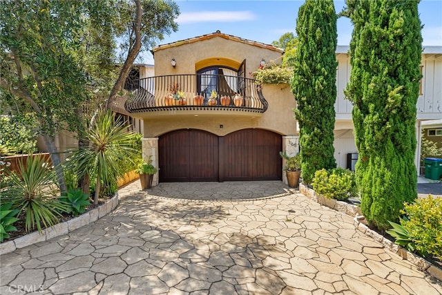 1165 Noria St, Laguna Beach, CA 92651 - mediterranean / spanish-style house featuring a balcony, driveway, a garage, and stucco siding