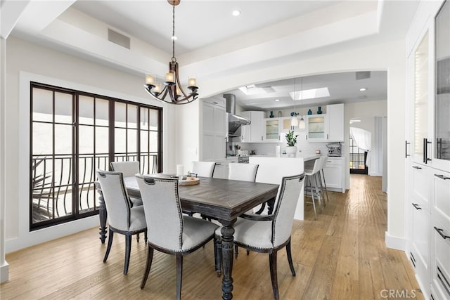 1165 Noria St, Laguna Beach, CA 92651 - dining area with arched walkways, a chandelier, light wood-type flooring, a tray ceiling, and recessed lighting