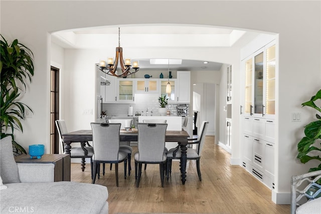 dining area featuring light hardwood / wood-style floors and an inviting chandelier