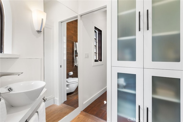 bathroom with vanity, toilet, and wood-type flooring