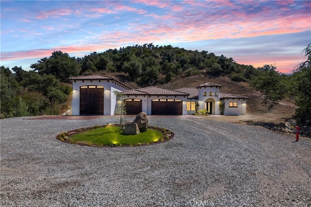 mediterranean / spanish-style house with a garage