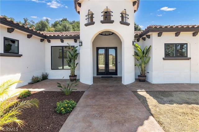 entrance to property featuring french doors and a patio