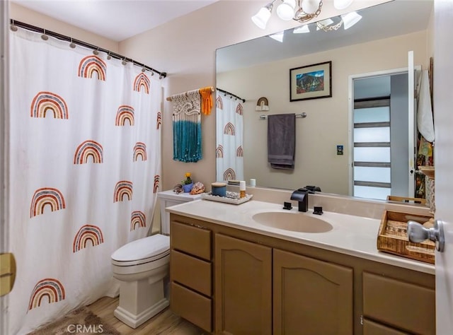 bathroom with a shower with curtain, vanity, and toilet