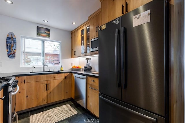 kitchen featuring dark tile patterned flooring, sink, and stainless steel appliances