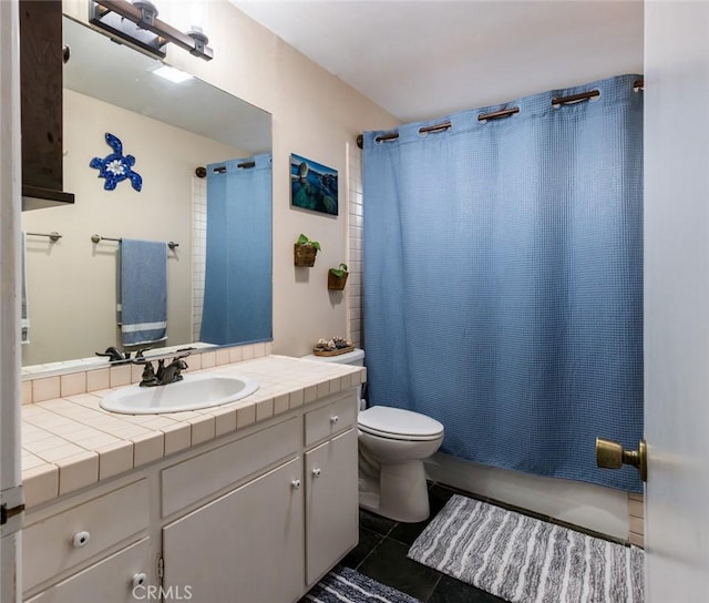 full bathroom with shower / bath combo with shower curtain, tile patterned flooring, vanity, and toilet