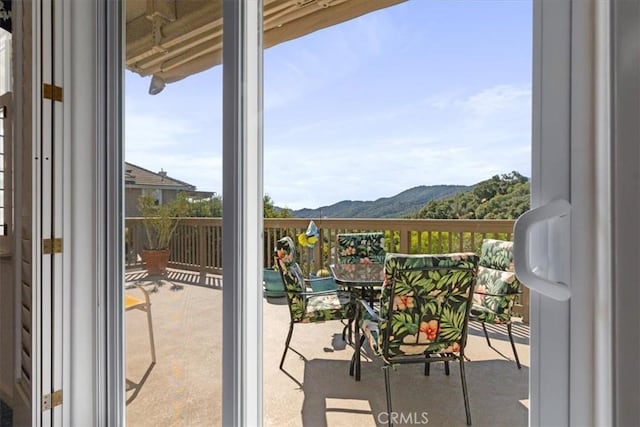 balcony featuring a mountain view and french doors