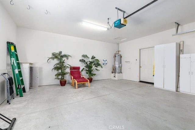 garage featuring secured water heater and a garage door opener