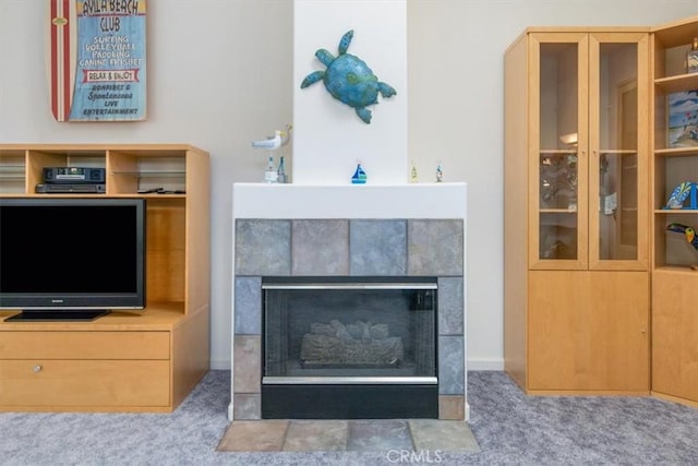 room details with carpet and a tile fireplace