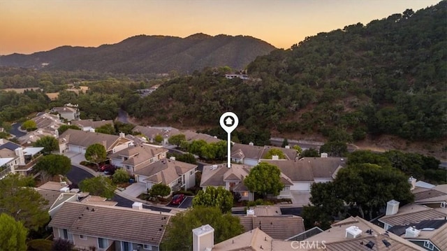 aerial view at dusk featuring a mountain view