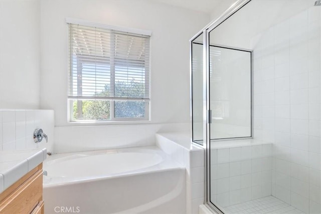 bathroom featuring vanity and shower with separate bathtub