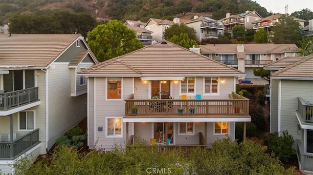 back of property featuring a balcony