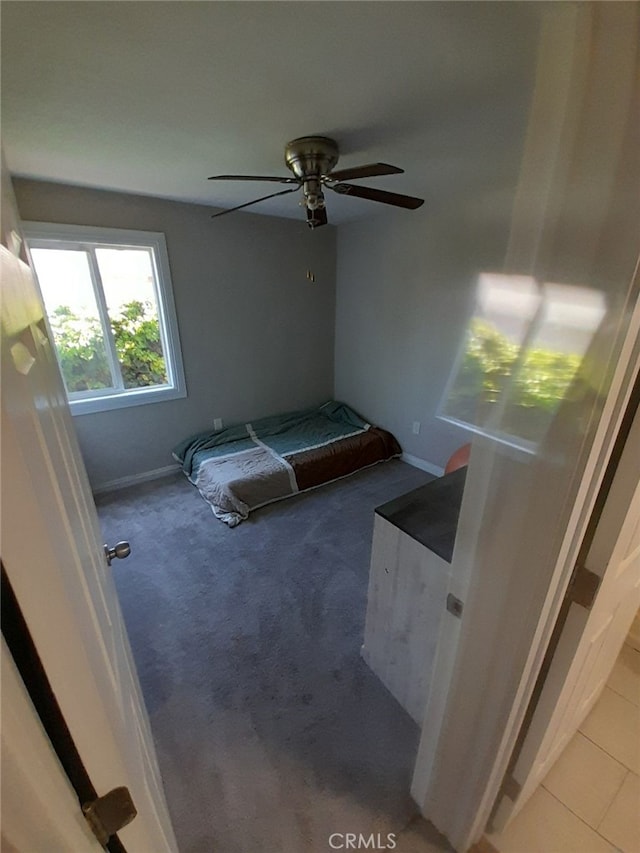 unfurnished bedroom with ceiling fan and carpet flooring