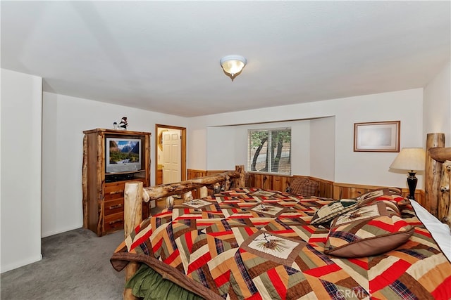 carpeted bedroom with wooden walls