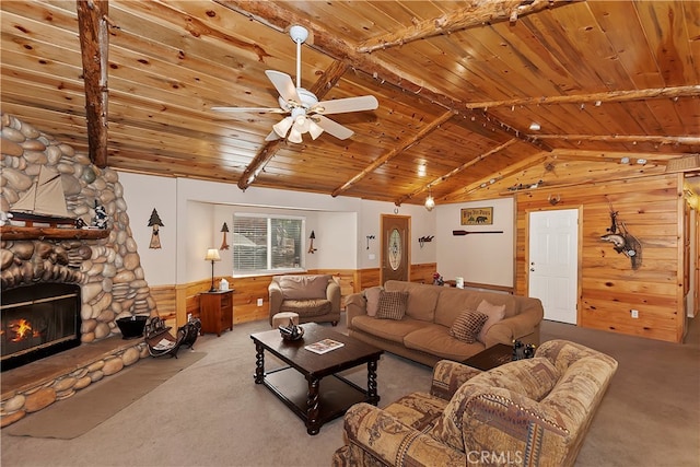 carpeted living room featuring a stone fireplace, wood walls, and wooden ceiling