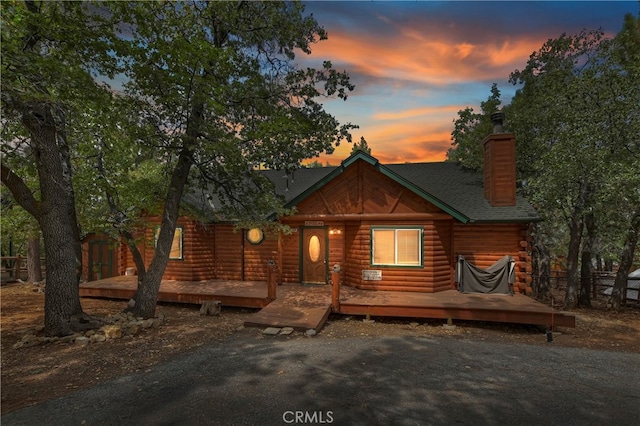 log cabin featuring a wooden deck