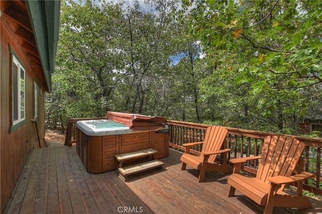 wooden deck featuring a hot tub