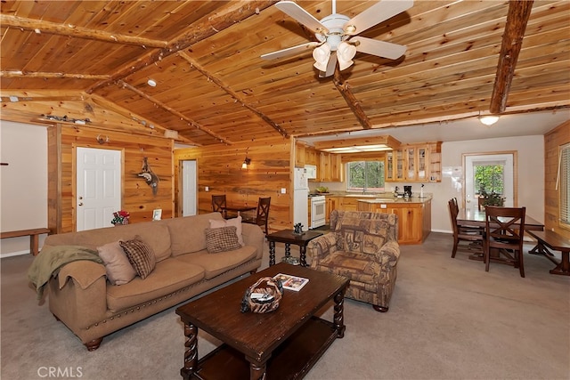 carpeted living room with wood ceiling, lofted ceiling with beams, wooden walls, and ceiling fan