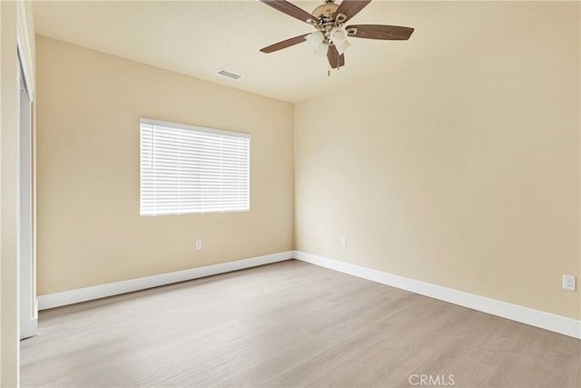 spare room featuring light wood-type flooring and ceiling fan