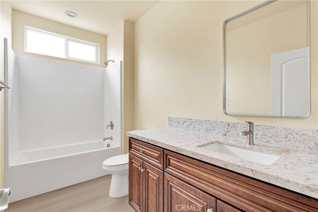 full bathroom featuring vanity, toilet, bathtub / shower combination, and hardwood / wood-style flooring