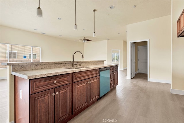 kitchen with pendant lighting, light wood-type flooring, sink, and stainless steel dishwasher