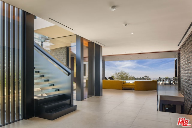 stairway featuring floor to ceiling windows