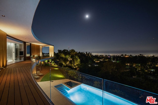 view of pool at twilight