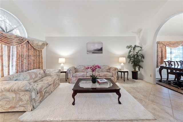 tiled living room with vaulted ceiling