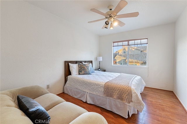 bedroom featuring hardwood / wood-style flooring and ceiling fan