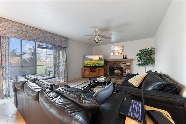 living room featuring a fireplace, light tile patterned floors, and ceiling fan