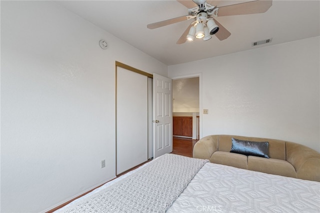 bedroom with ceiling fan and a closet