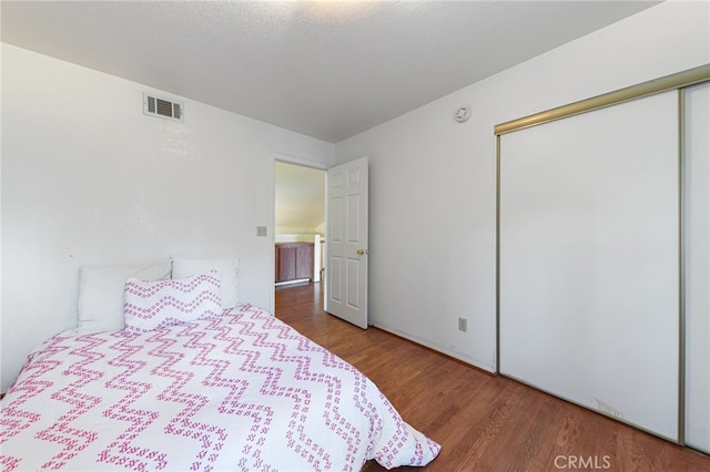 bedroom featuring a closet and hardwood / wood-style floors