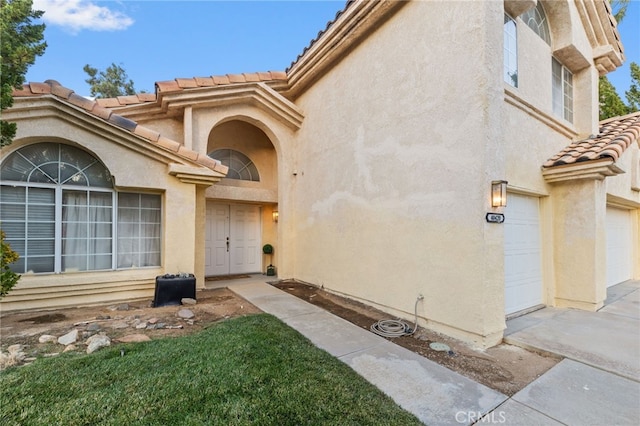 view of exterior entry featuring a garage