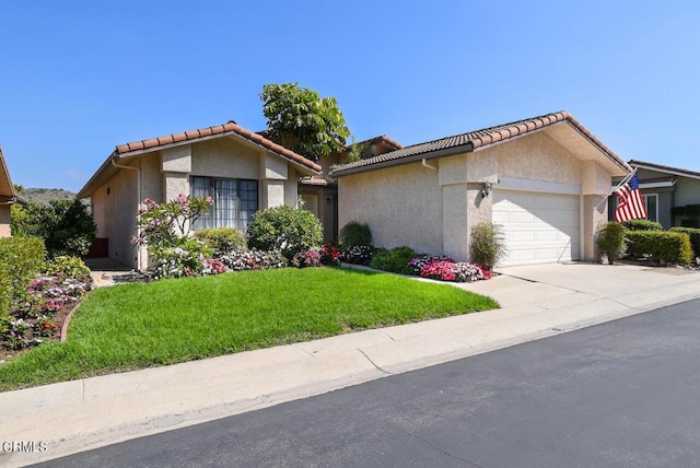 ranch-style home with a front lawn and a garage