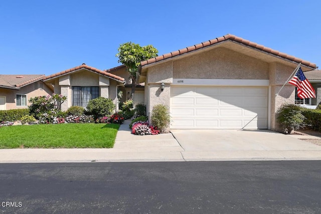 view of front of house featuring a front yard and a garage