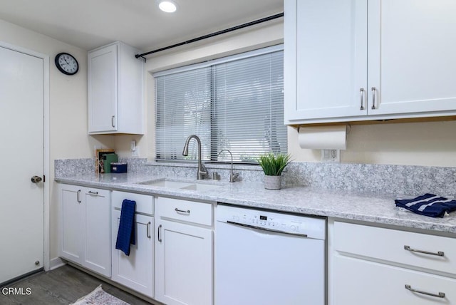 kitchen featuring light stone counters, sink, dishwasher, dark hardwood / wood-style floors, and white cabinetry