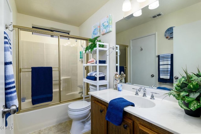 full bathroom with tile patterned floors, vanity, toilet, and shower / bath combination with glass door