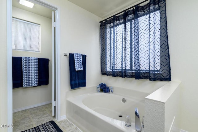 bathroom featuring tile patterned floors and a washtub