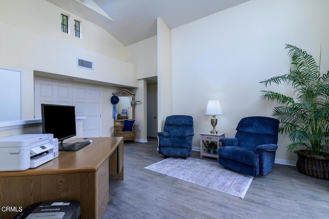 office featuring high vaulted ceiling and dark wood-type flooring