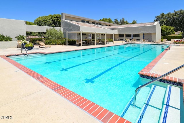 view of swimming pool with a patio