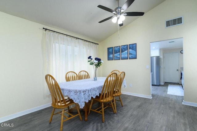 dining room with ceiling fan, high vaulted ceiling, and dark wood-type flooring