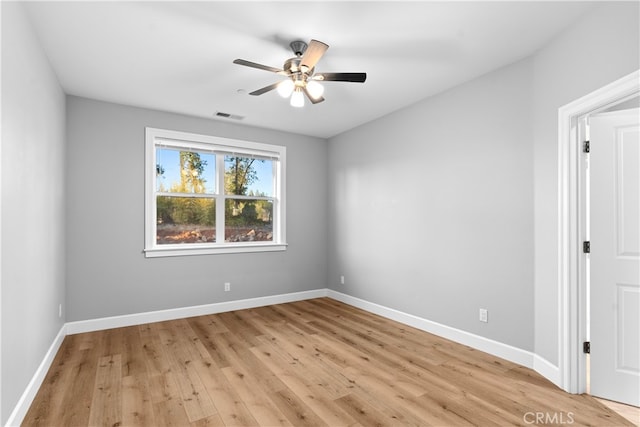 spare room with ceiling fan and light wood-type flooring