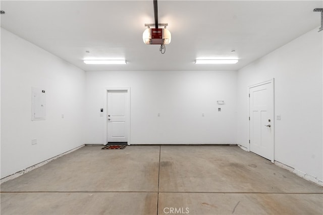 garage featuring electric panel and a garage door opener