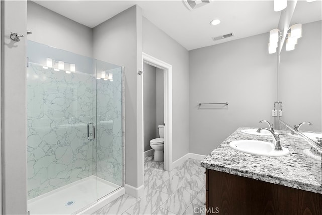 bathroom with vanity, toilet, and an enclosed shower