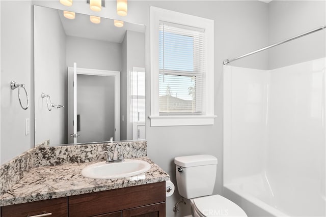 full bathroom featuring shower / bathing tub combination, vanity, and toilet