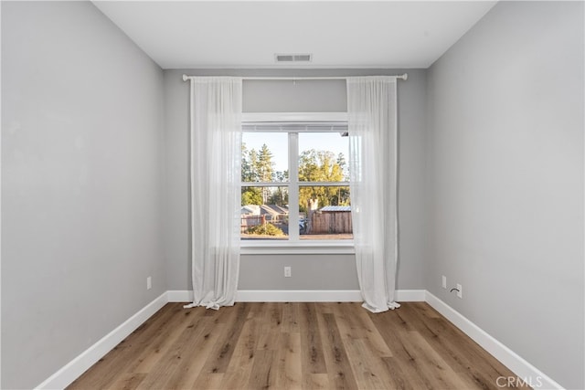 spare room featuring light wood-type flooring