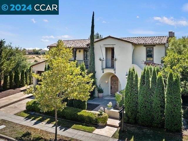 mediterranean / spanish home featuring a balcony