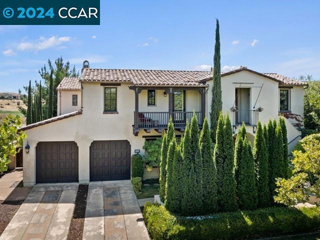 mediterranean / spanish-style house featuring a balcony and a garage