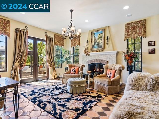 living area with an inviting chandelier and french doors