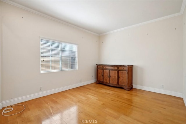 unfurnished room featuring crown molding and light hardwood / wood-style flooring